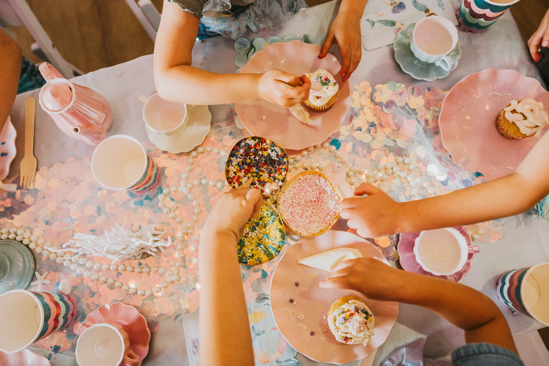 Children decorating cupcakes during a birthday celebration