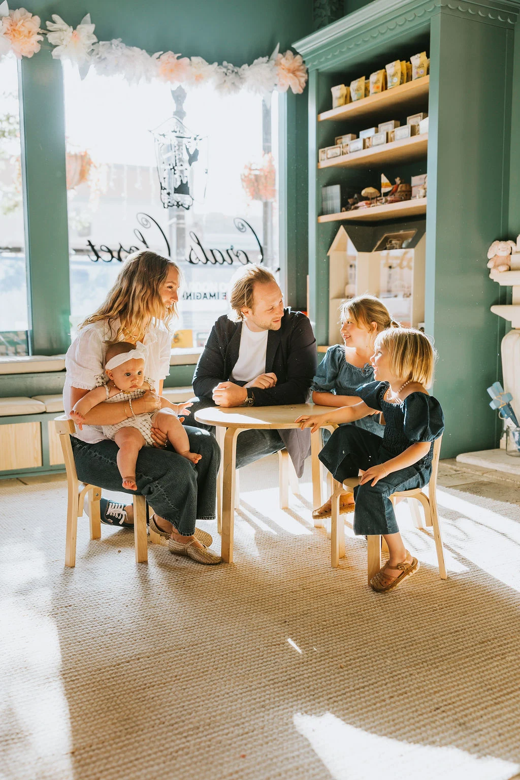 A family sharing time around a table at Corals Closet