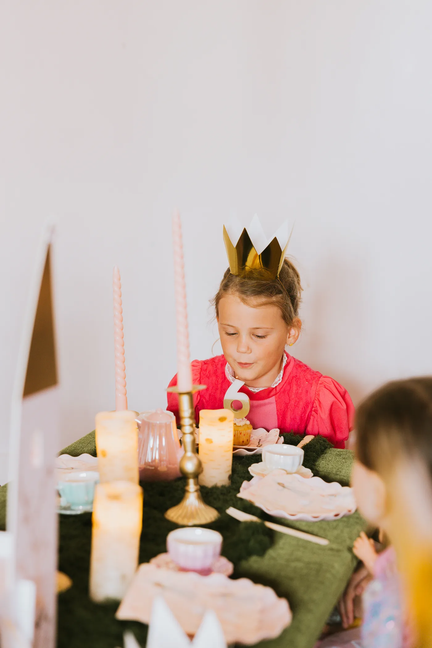 A child celebrates at an Enchanted Forest party table