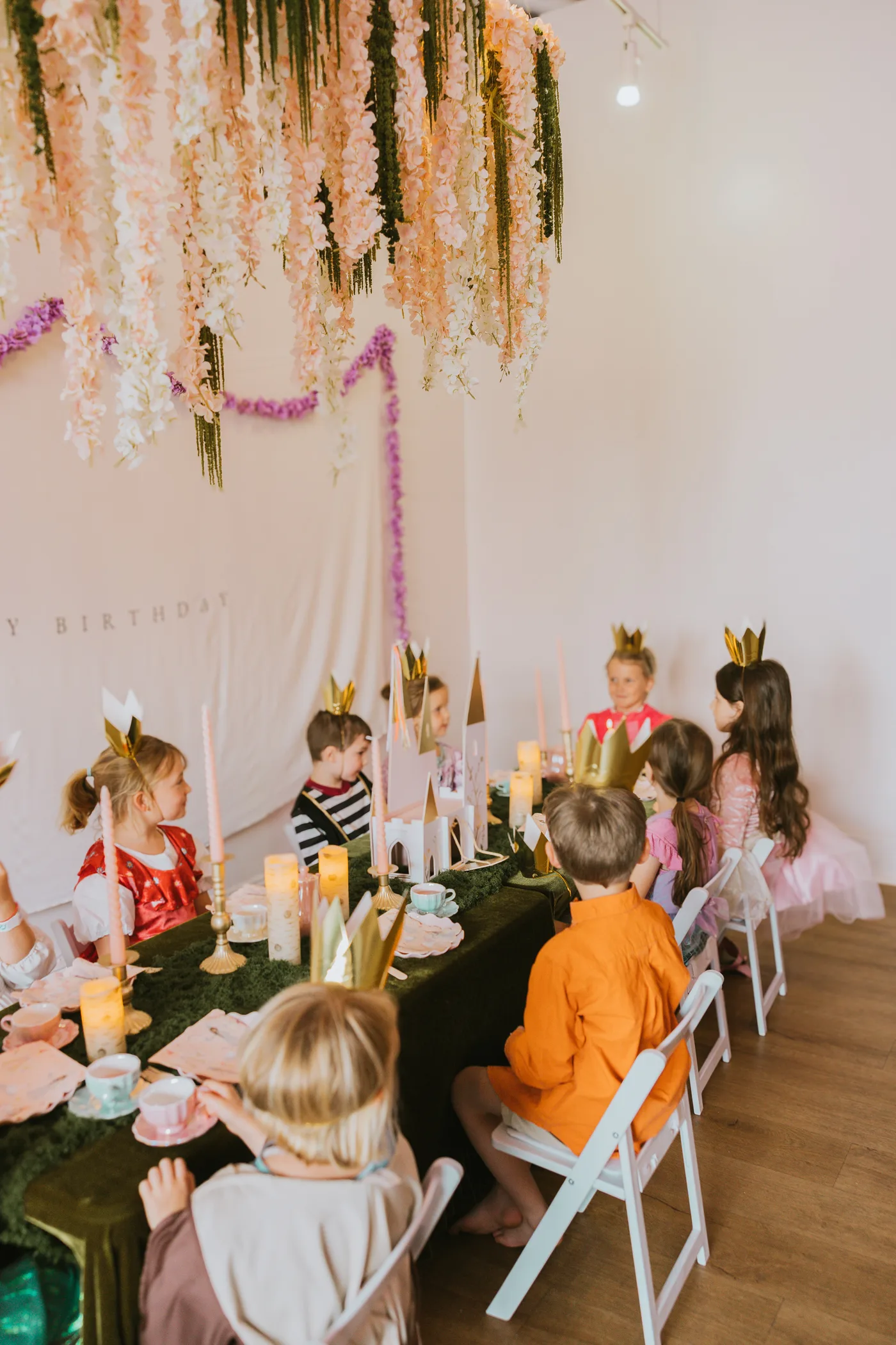 Children celebrating beneath floral decor