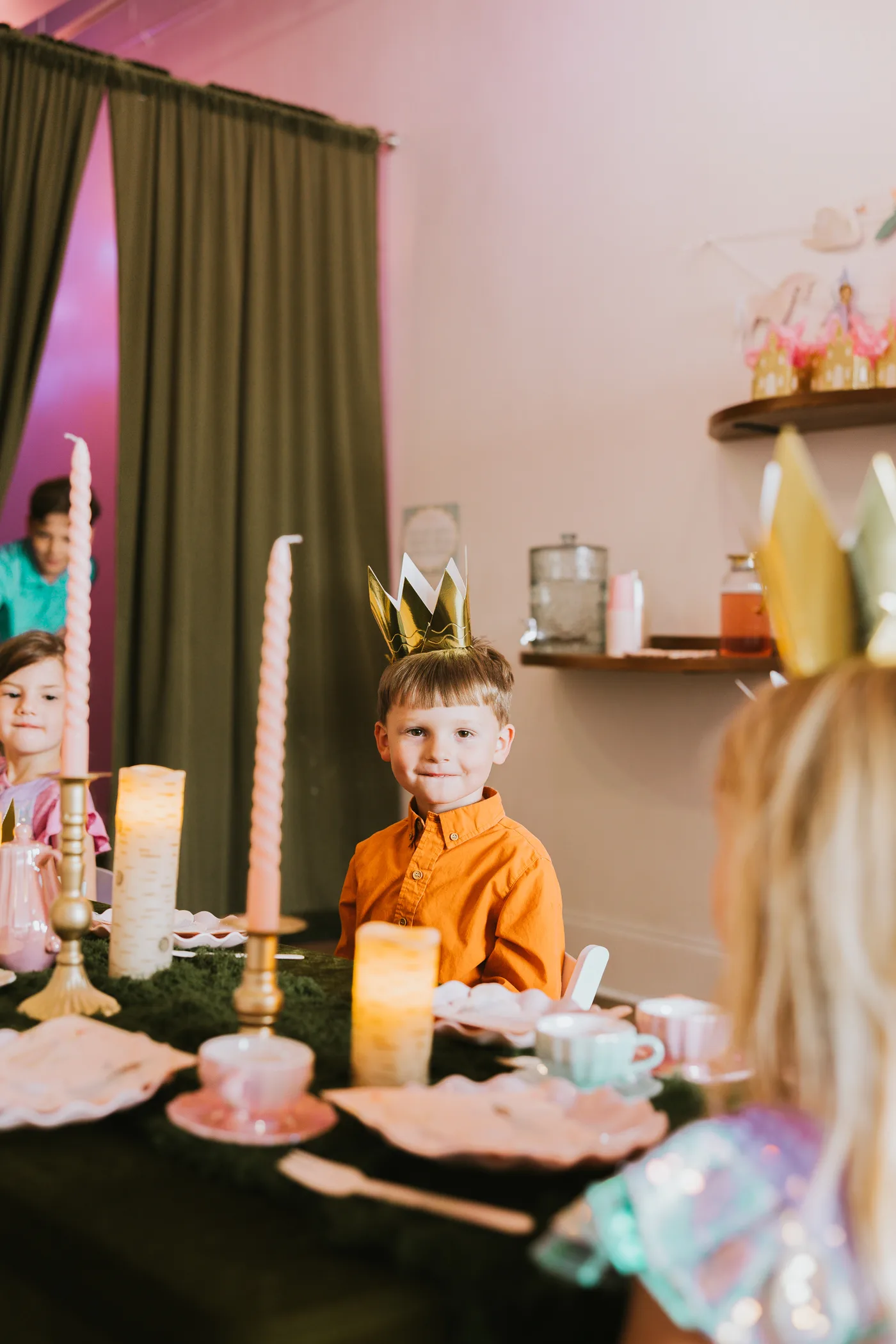 A crowned guest enjoying the forest-themed celebration