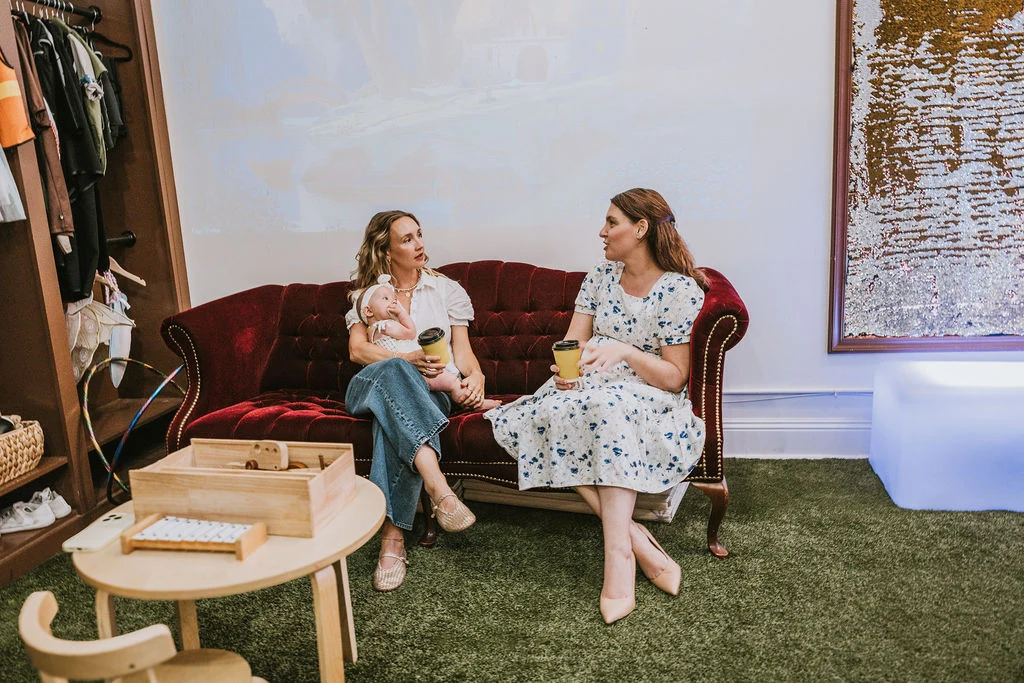 Grown-ups enjoying coffee and conversation at Corals Closet
