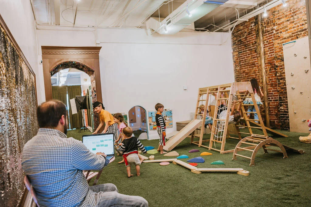 Children at play while a grown-up relaxes at Corals Closet
