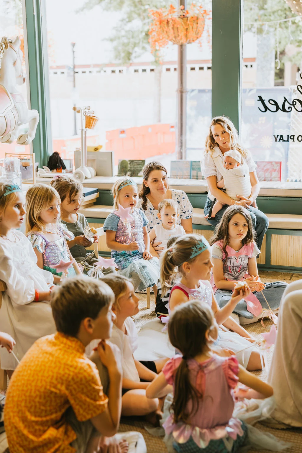 Children listening together during storytime at Corals Closet